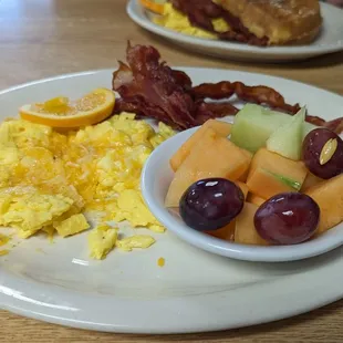 Egg and bacon plate with fruit (scrambled with cheese)