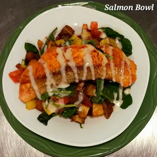 a plate of salmon with vegetables