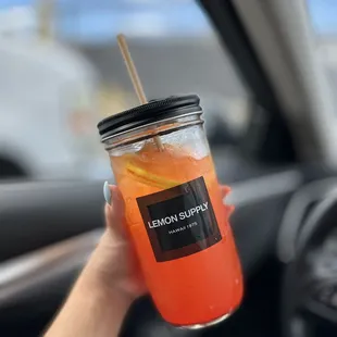 a person holding a drink in a car