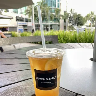 a drink in a plastic cup on a table