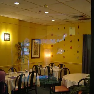 a dining room with yellow walls