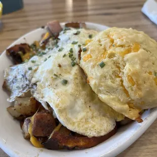 Bacon and ham and cheese and potatoes with eggs and a biscuit YUM