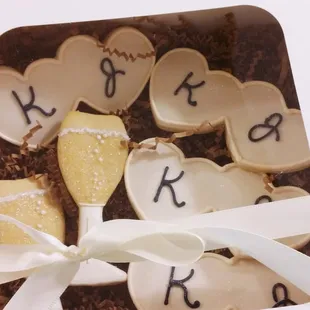 Gorgeous gift box of initialed double-hearts and champagne flutes.