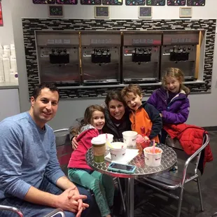 a family sitting at a table