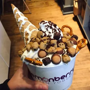 a hand holding a cup of ice cream