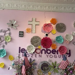 a wall with flowers and a cross