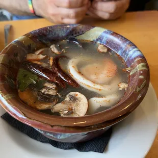 Lemongrass soup with seafood: scallop, shrimp, calimari, and mussels.