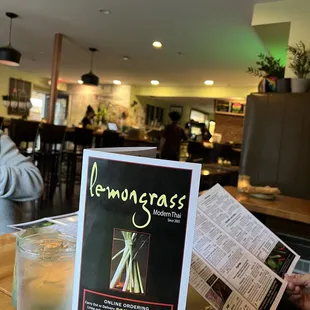 a menu and a glass of lemonade