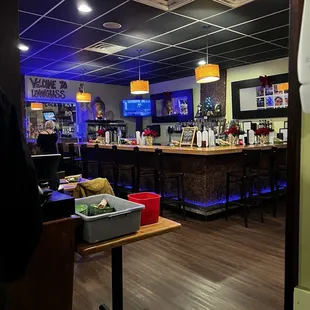 a bar with a counter and chairs