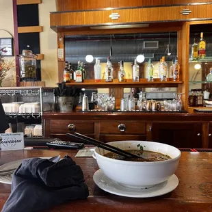 a bowl of soup and chopsticks