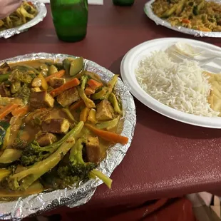 Combo plate with tofu (including rice and naan), right side is fried rice with chicken, left side is rice noodles with chicken.