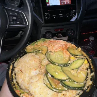 a person holding a plate of food