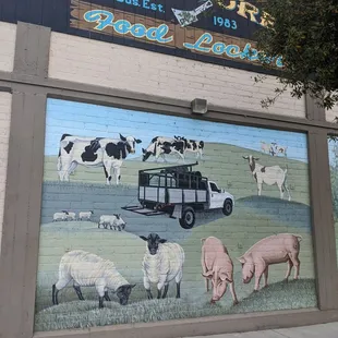 farm animals painted on the side of a building