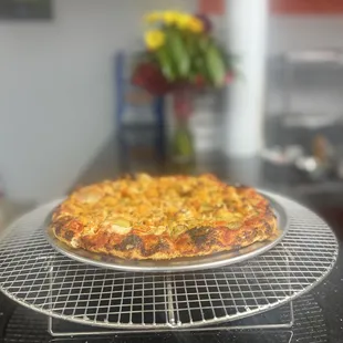 a pizza on a cooling rack
