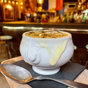 a bowl of soup and a spoon on a table