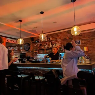 a group of people sitting at a bar