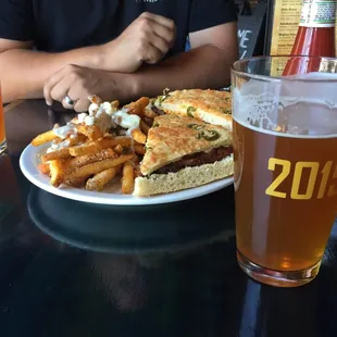 Tri-tip sandwich with stanky fries with a centennial