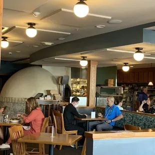 people sitting at tables in a restaurant