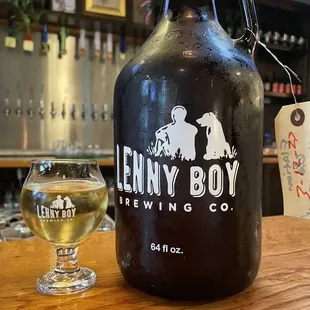 a glass of beer and a growler
