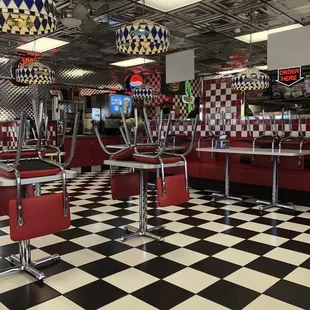 a checkered floor and red booths