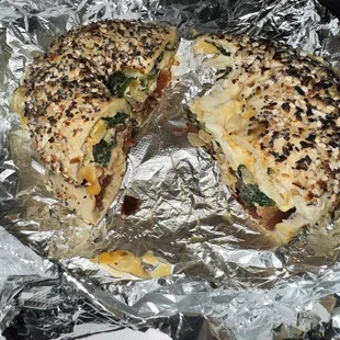 This picture does no justice. Egg white onion spinach cheese and bacon on a everything bagel