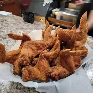 a basket of fried chicken on a counter
