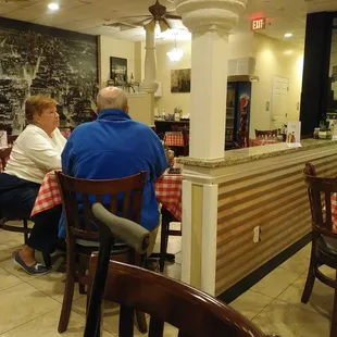 You can now clearly see the bottle of cleaner on the waitress station just to the right side of the guy in the blue jacket