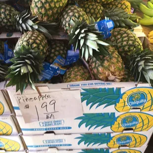 a display of pineapples and bananas