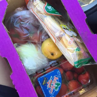 I spent $4.71 for everything in this box. Rice crackers, 3 tomatoes on the vine, strawberries, a mango, and a sweet onion.