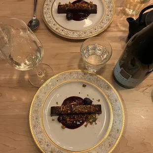 two plates of food on a wooden table