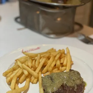 a steak and french fries on a plate