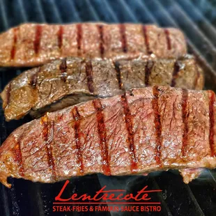 three steaks on a grill