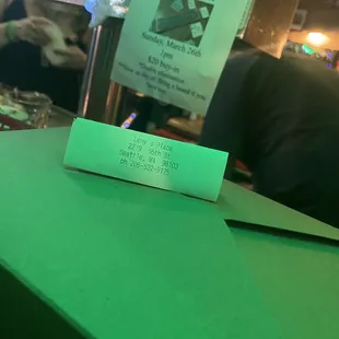 a green table with a menu on it