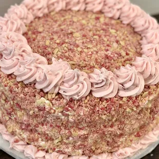 a strawberry cake with pink frosting