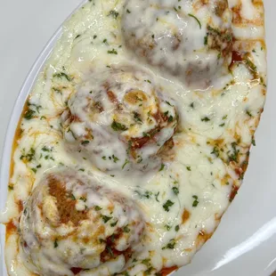 three meatballs on a white plate