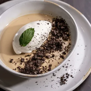 a bowl of dessert with whipped cream and chocolate