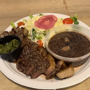 Picanha steak with black beans, a salad and chimichurri