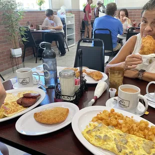 Mushroom omelette, empanadas, mangu platter, roasted potatoes.