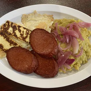 Mangu (mashed plantains with onions, fried cheese, egg, and Dominican sausage)