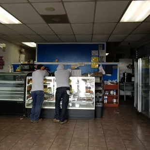 two men standing in front of the counter