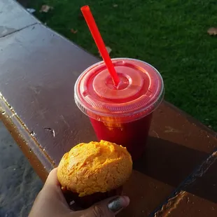 Beets, celery, carrot, and orange juice drink with a cupcake.