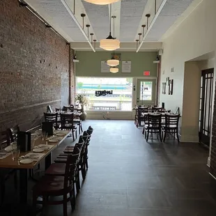 a long dining room with tables and chairs