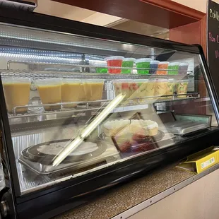 a display case with a variety of desserts