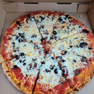 Large pizza with ground beef, olives, and onion.