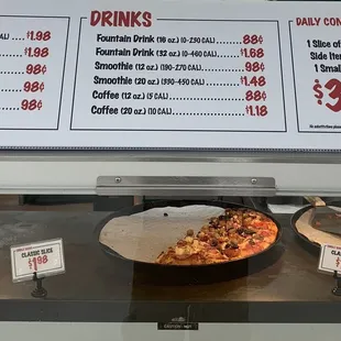 two pans of pizza on a counter