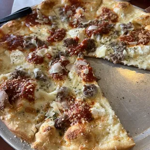 a pizza with a slice taken out of it