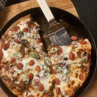 Pizza - with tomatoes, green peppers, mushrooms, olives and sausage.