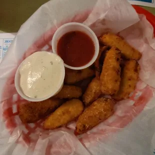 a basket of fried fish and dipping sauce