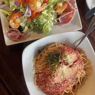 Salad with shrimp added and Spaghetti with meatballs in a marinara sauce