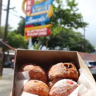Half dozen malasadas puffs (2x guava, custard, huapia, macadamia, dobash). Plus an original malasada and a Li Hing malasada